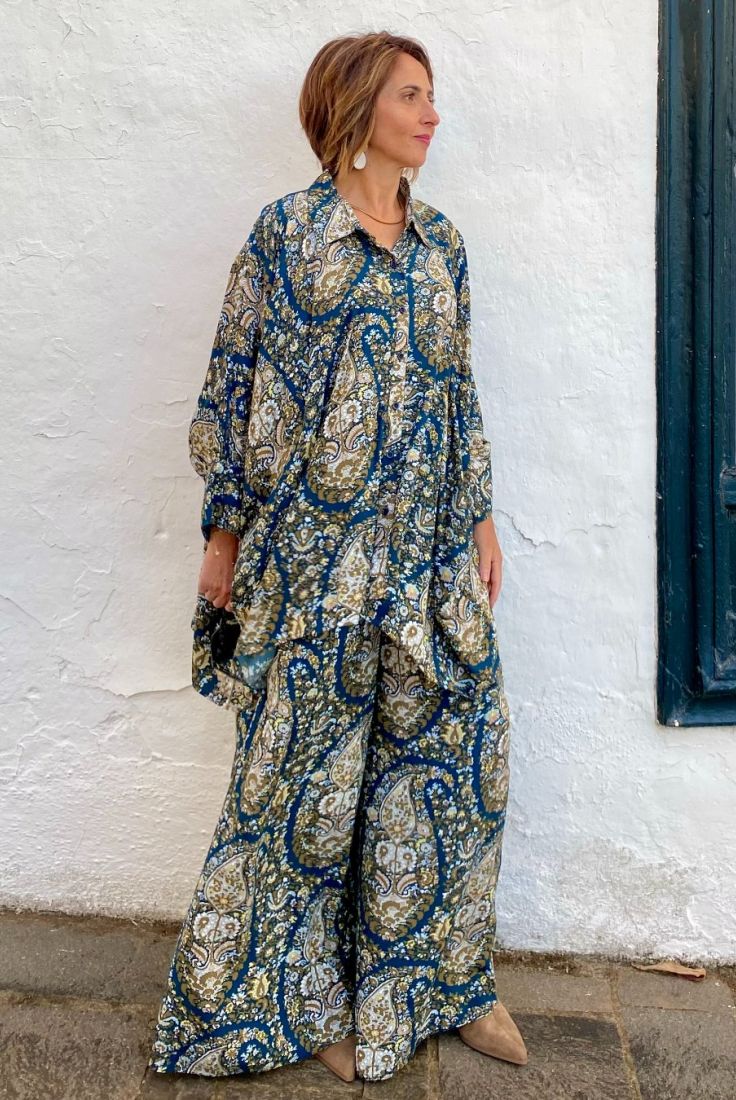 Mujer vestida con conjunto oversize de blusón y palazzo, estampado en tonos marinos y tierras, con paisley, de esencia boho chic